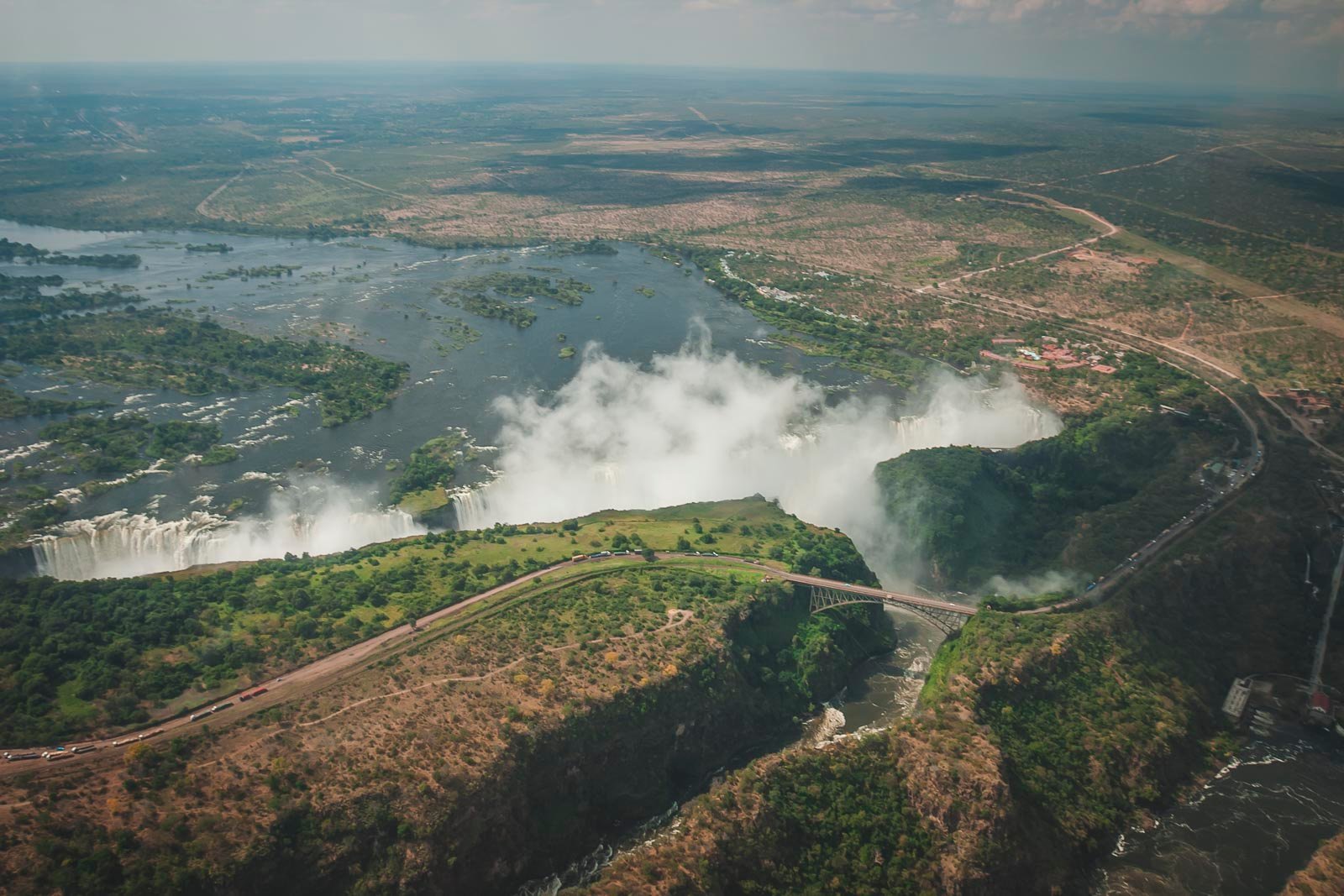 Victoria Falls waterfall with rainbow over Zambezi Gorge