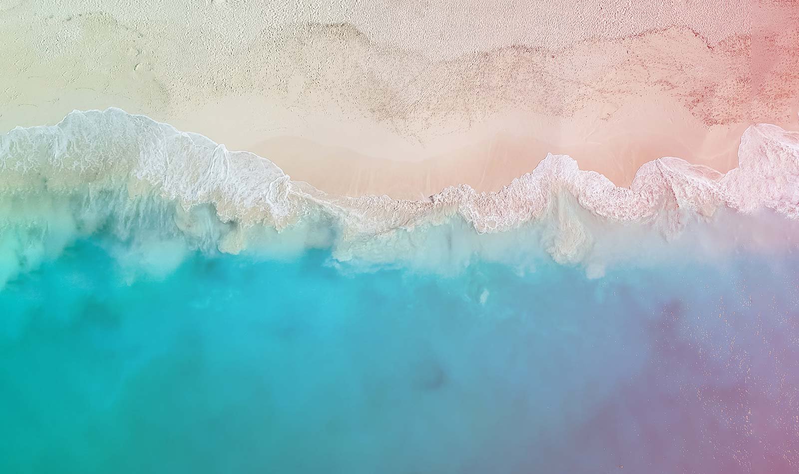 An aerial view of the ocean and sand in the Turks and Caicos Islands