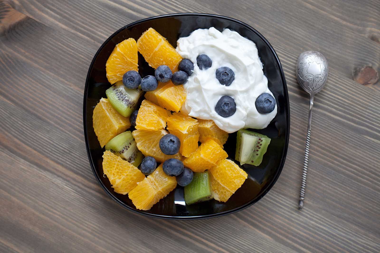 Bowl of skyr Icelandic yogurt topped with fresh berries and honey.