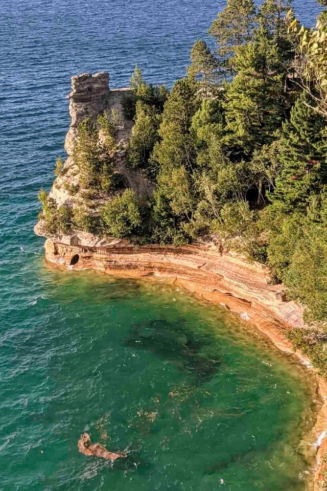 A dramatic view of the ancient Black Rocks at Presque Isle Park in Marquette, a famous spot for cliff jumping into Lake Superior