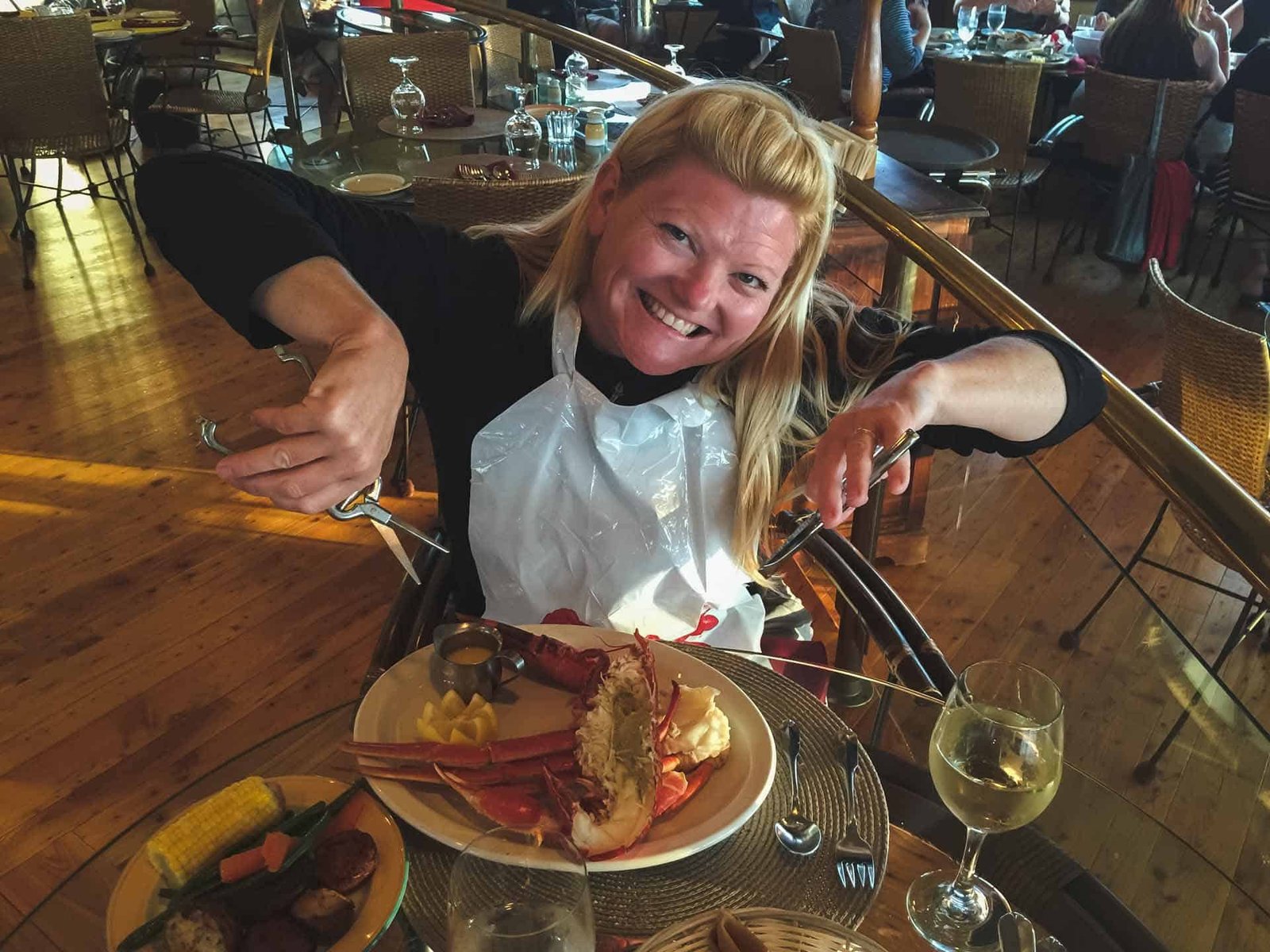 Deb from The Planet D digging into A fresh Nova Scotia lobster served with a side of chips.