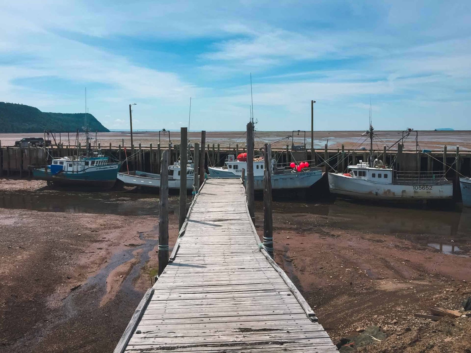 Fishing boats sit on the ocean floor at low tide in Hall's Harbour in Nova Scotia