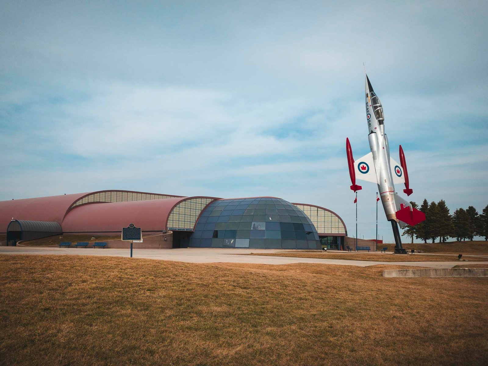 Exterior of the canadian warplane heritage museum with a Canadian fighter jet out front.