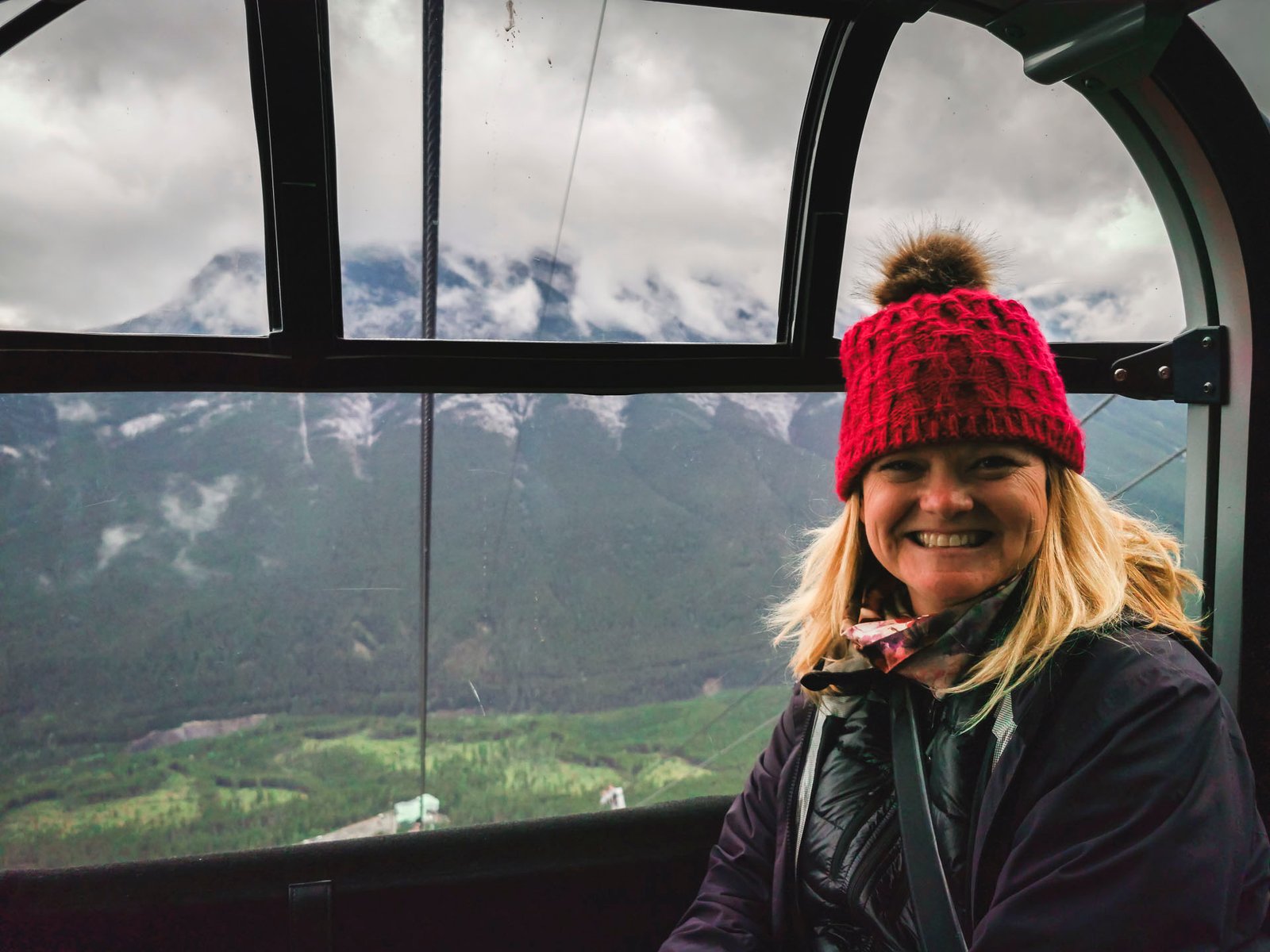 Deb from The Planet D on the Jasper SkyTram on Whistlers Mountain with a  stunning panoramic view of the Rocky Mountains in the background