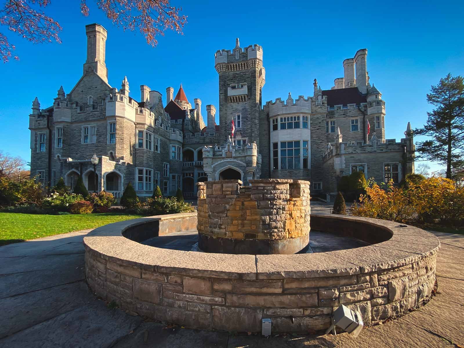 A grand exterior view of the historic Casa Loma castle in Toronto, seen from its beautiful gardens.