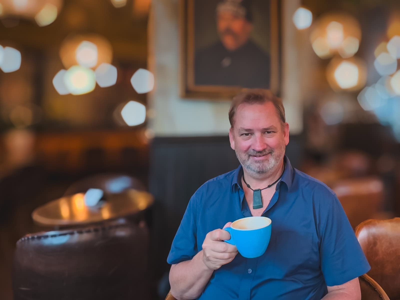 Dave from The Planet D sitting at an outdoor cafe table, enjoying the classic Parisian atmosphere in Saint-Germain.