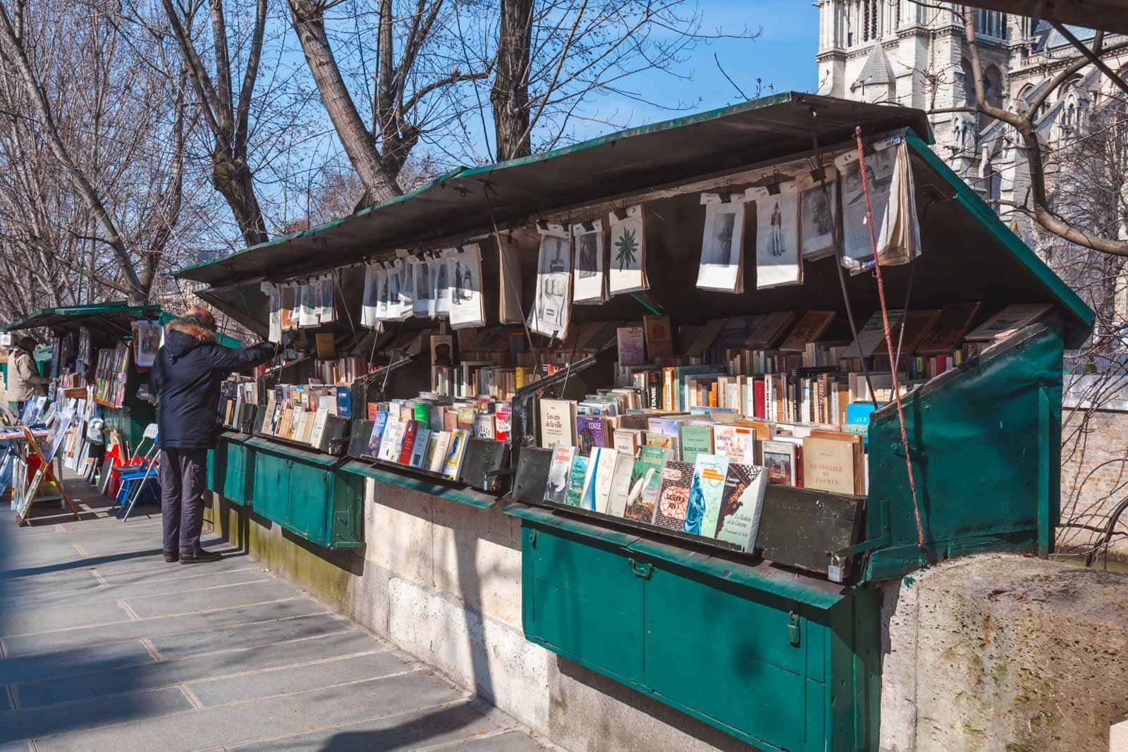 Bookshops along the Seine in the Latin Quarter, with Notre Dame Cathedral in the background.