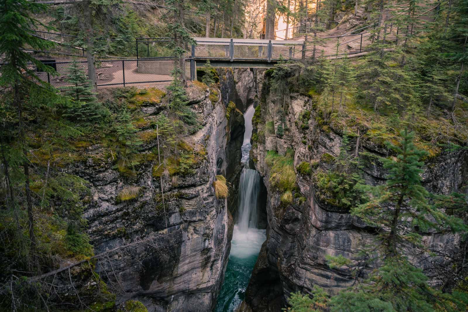 Walking the trail of the Maligne Canton hike in summer with waterfalls all around
