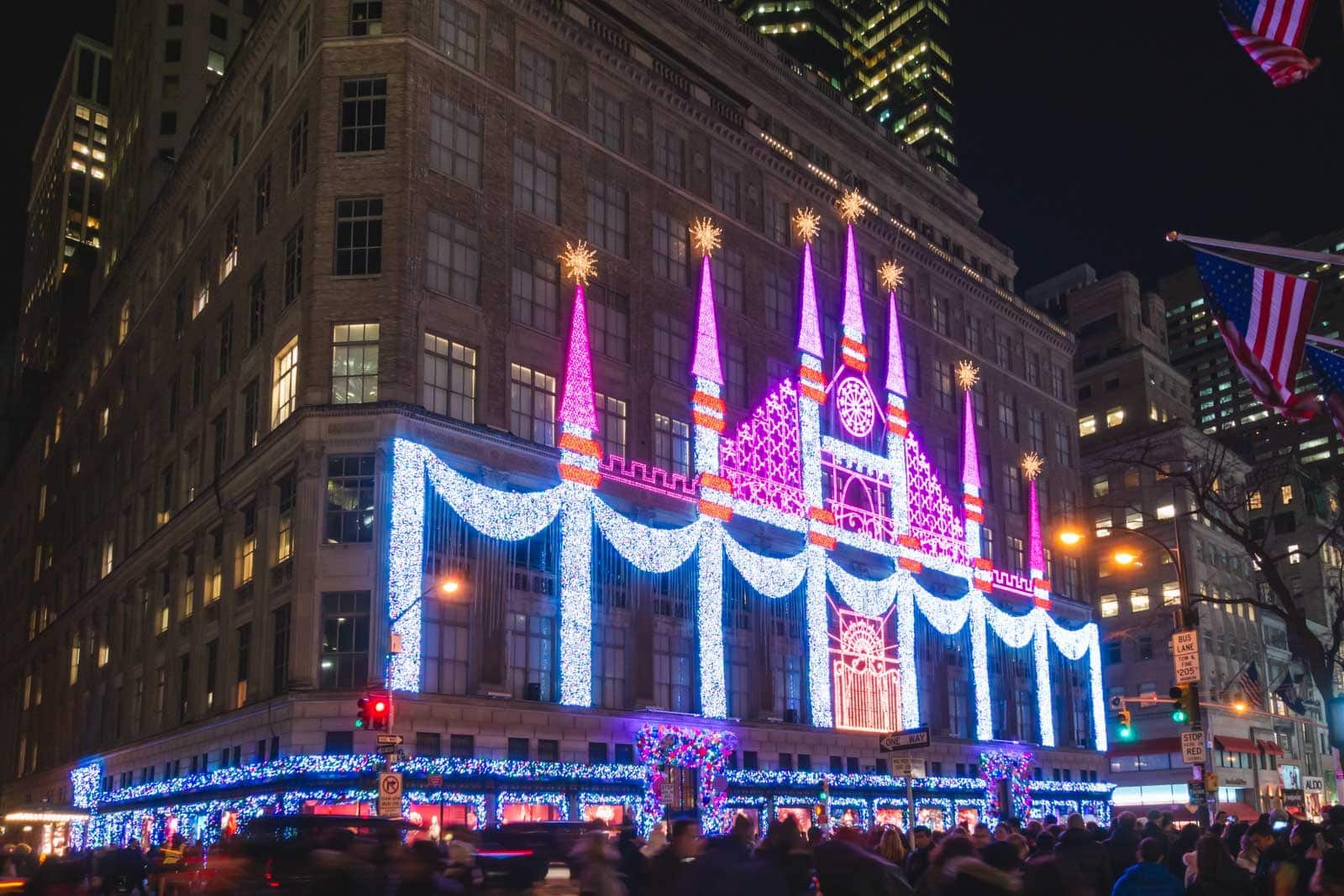 The entire facade of the Saks Fifth Avenue department store illuminated with a spectacular Christmas light show at night.