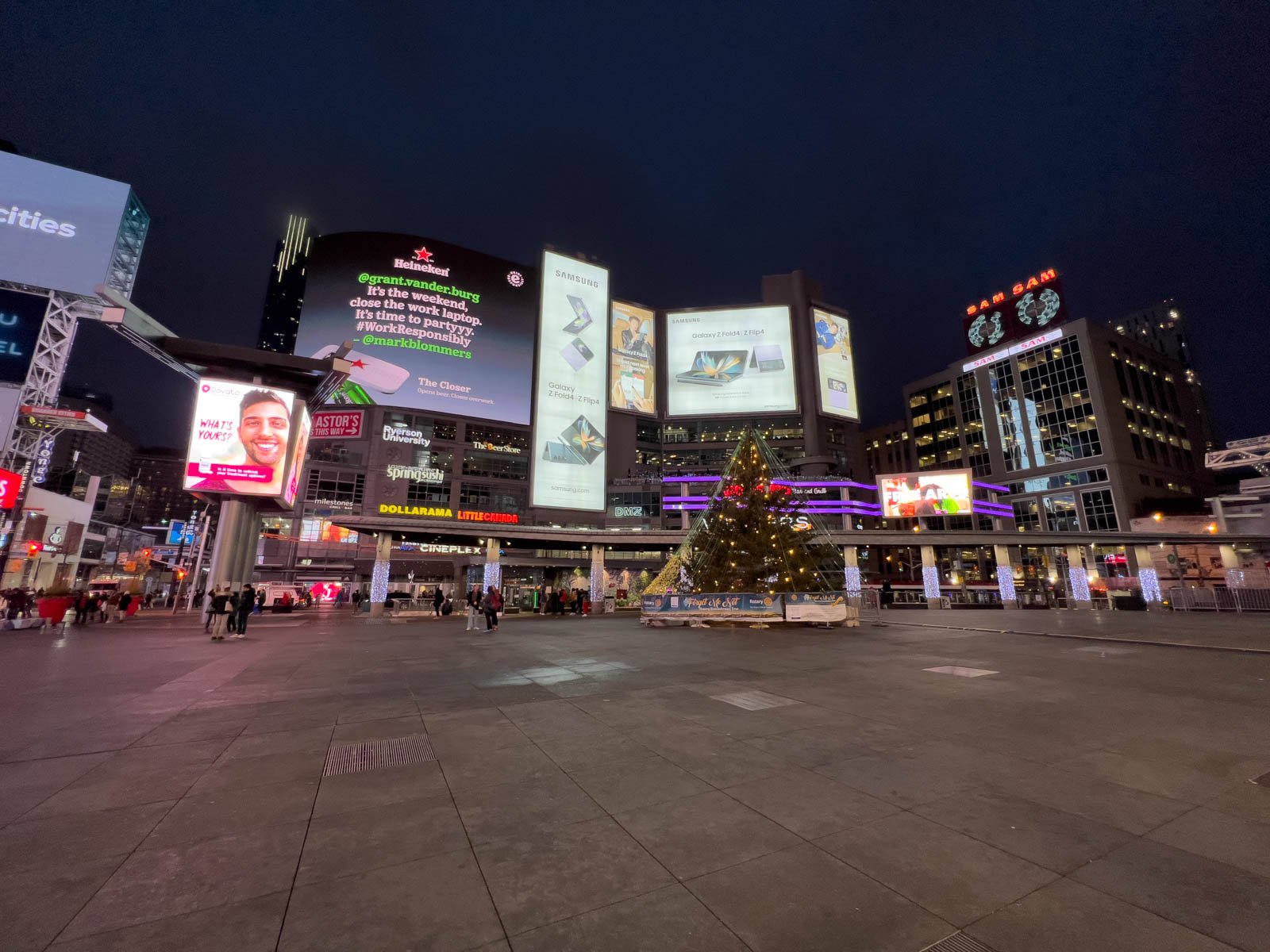 The bright, flashing billboards and vibrant energy of Yonge-Dundas Square in Toronto at night.