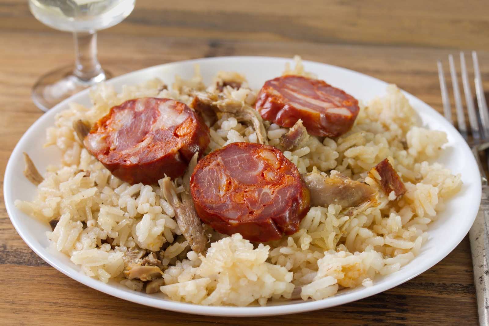 A savoury dish of Arroz de Pato, a traditional Portuguese duck rice baked with chouriço on top.