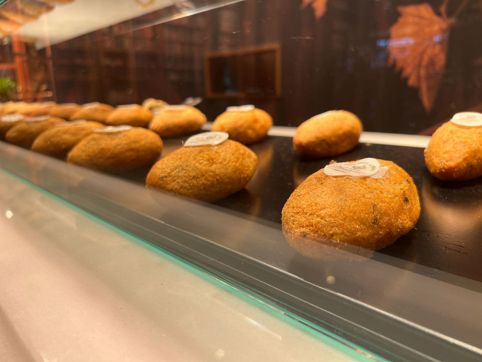 A display of crispy, golden-brown Bolinhos de Bacalhau, a popular Portuguese food snack.