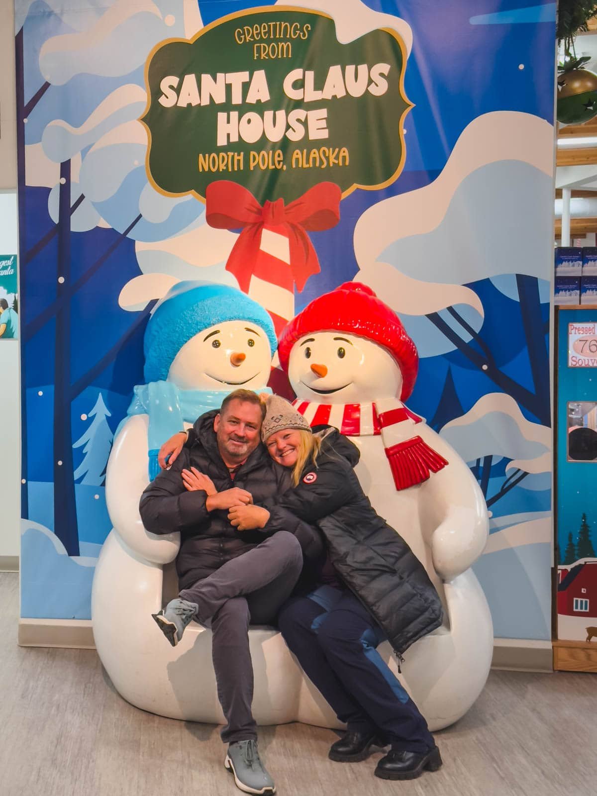Dave and Deb at the festive Santa Claus House in North Pole, Alaska, one of the best places to visit in December.