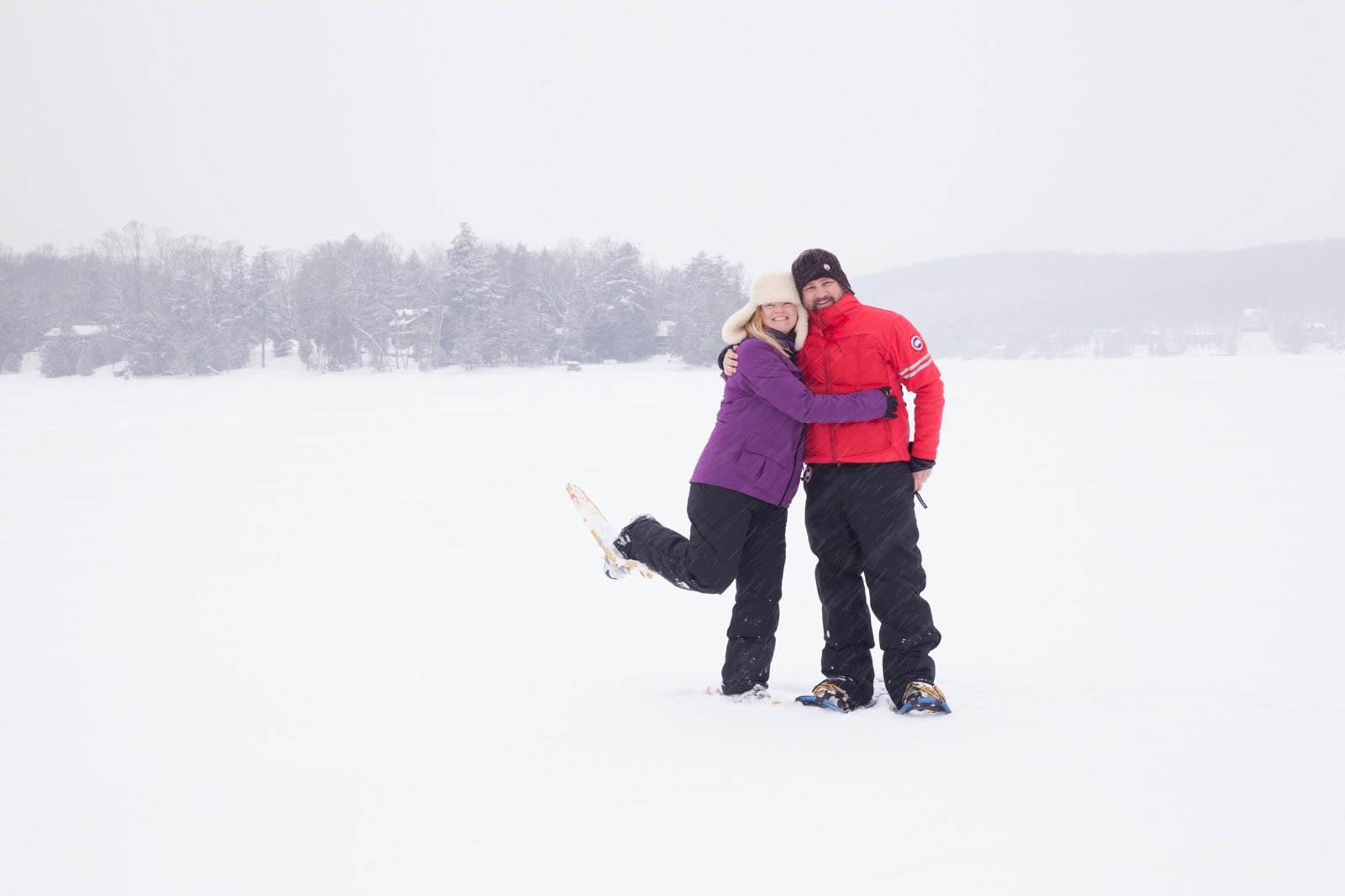 Dave and Deb of The Planet D bundled up and smiling on a snowy winter adventure